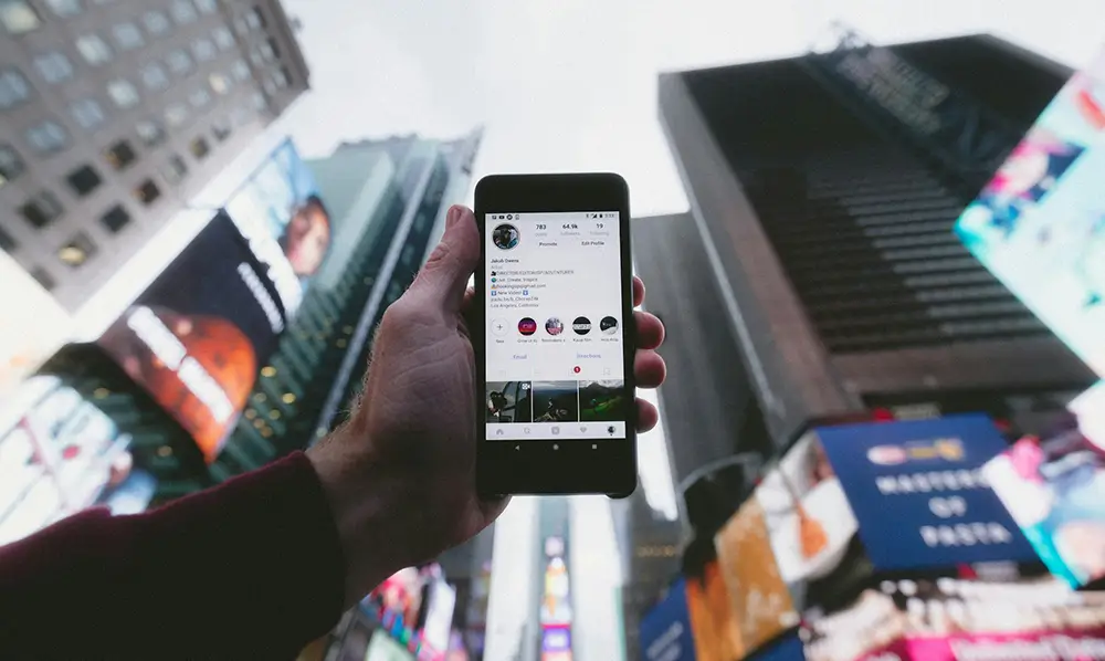 Phone being held with social media on the screen